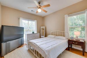a bedroom with a bed and a flat screen tv at Inviting Austell Home 14 Mi to Downtown Atlanta! in Austell