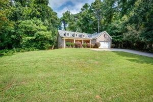 a large house with a large grassy yard at Inviting Austell Home 14 Mi to Downtown Atlanta! in Austell