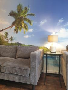 a living room with a couch and a palm tree mural at BrumStay UK - 4 Bedrooms House with Garden, Parking and Fibre Broadband with speed upto 250mbps in Birmingham