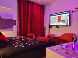 a bedroom with a bed with flower petals on it at Love & Spa in Avignon