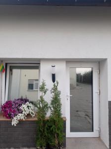 a front door of a house with flowers at Apartment hotels parking akaciju1 in Vilnius