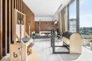 a gym with treadmills and machines in a room at Palácio Estoril Hotel, Golf & Wellness in Cascais