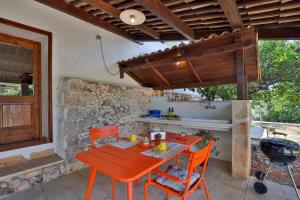 a patio with a table and chairs and a grill at Agriturismo Masseria Gianferrante in Ugento