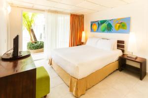 a bedroom with a bed and a television in it at Decameron Los Delfines - All Inclusive in San Andrés