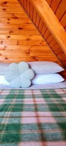 a bed with two pillows on top of it at Saka Bungalov 