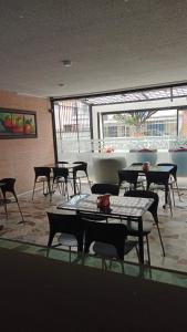a room with tables and chairs in a building at Hotel AG Boutique in Bogotá