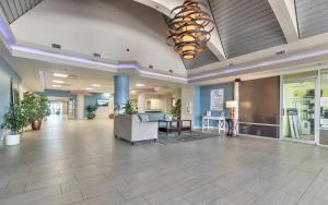 an empty lobby with a couch and a table at Sunkissed-Modern Oceanfront Condo Daytona Beach in Daytona Beach +19 photos