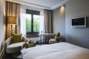 Ein Bett oder Betten in einem Zimmer der Unterkunft Insel-Hotel Heilbronn