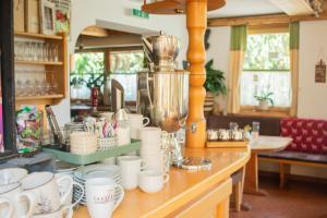 a counter with a bunch of cups on it at Hotel Forsthof in Sankt Johann im Pongau