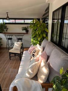 a living room with a couch with pillows on it at Casa Privado- 2 Bedroom House Near the Airport in Puerto Princesa City