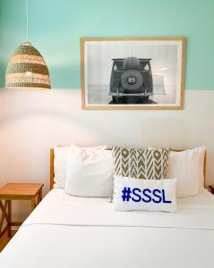 a picture of a camera on top of a bed at Seaspray Surf Lodge in Vero Beach