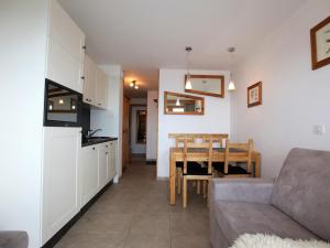 a living room with a couch and a table at Charmant studio cabine avec WiFi à Avoriaz - FR-1-314-159 in Morzine