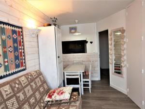 a small living room with a table and a couch at Appartement Avoriaz, 2 pièces, 4 personnes - FR-1-314-190 in Morzine