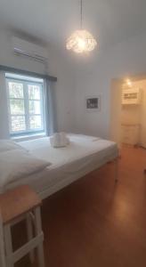 a large bed in a room with a window at Little Troll House 1 in Chrissi Akti