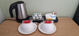 a coffee maker and two teapots on a table at Vale of York restaurant and rooms in Thirsk