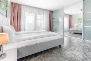 a bedroom with a bed and a glass wall at Casa Fischer in Ciheiu