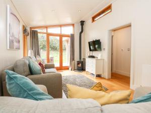 a living room with a couch and a tv at Harley's House in Oakham