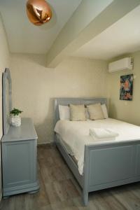 a bedroom with a bed and a table with a lamp at Hostal 53 Boutique Santo Domingo in Santo Domingo