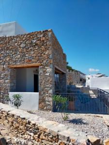 a stone house with a stone wall at Amorgos Elegant Houses, Villa 3 in Aegiali +43 photos