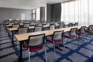 a room with rows of tables and chairs at TownePlace Suites by Marriott Orlando Airport in Orlando