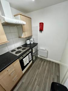 a kitchen with a stove and a counter top at Bradford Service accommodation in Bradford