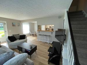 a living room with a couch and a table at New Stylish Condo Monthly Rental in Reminderville