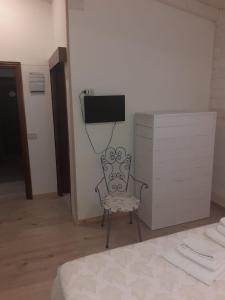 una camera con letto, sedia e cassettiera di Villa Lina Bed&Breakfast a Taranto