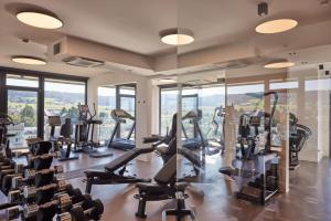 a gym with a lot of treadmills and ellipticals at Impulshotel FREIGOLD in Freistadt