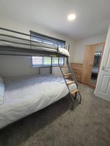 a bedroom with a bunk bed in a room at Perfect for family getaways in West Thurrock