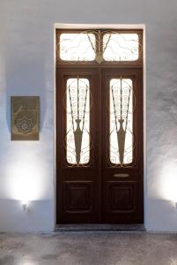 a wooden door with a pair of footprints on it at Jensen Luxury Suites in Rhodes Town