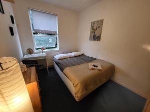 a small bedroom with a bed and a window at Quiet Room Near Arsenal Stadium Islington Zone 2 Cental in London