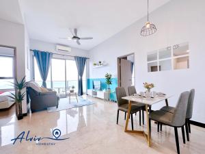 a living room with a table and a dining room at Silverscape - Luxury 3-4BR with Bathtub I 6-11pax I Infinity Pool I JonkerSt - Managed by Alviv Homestay in Melaka