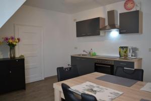 a kitchen with a table and a kitchen with a counter at Pension,Ferien, Monteurwohnung , Unterkunft,Zimmer in Schönebeck +7 photos