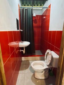 a bathroom with a toilet and a sink at Casa Caracol in Montañita