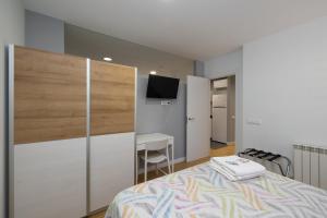 A bed or beds in a room at ALQUILAZ Apartamentos Turísticos