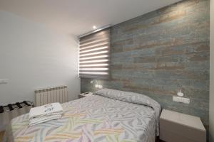 A bed or beds in a room at ALQUILAZ Apartamentos Turísticos