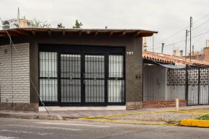 a building with a large gate on a street at Departamento en Mendoza Biznaga in Mendoza