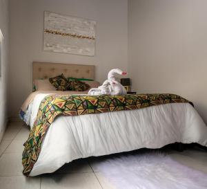 un dormitorio con una cama con un animal de peluche en Departamento en Mendoza Biznaga en Mendoza