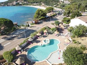 an aerial view of a swimming pool and the beach at Résidence le Télémaque in Conca