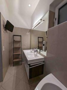 a bathroom with a sink and a toilet and a mirror at Luxury CityApartment 7 in Vienna