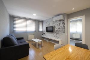 A television and/or entertainment centre at ALQUILAZ Apartamentos Turísticos