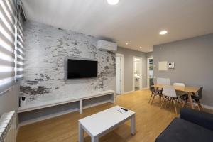A television and/or entertainment centre at ALQUILAZ Apartamentos Turísticos