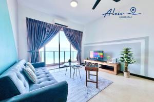 a living room with a blue couch and a table at Silverscape - Luxury 3-4BR with Bathtub I Infinity Pool I JonkerSt - Managed by Alviv Homestay in Melaka