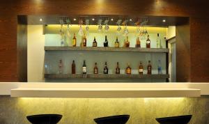 a display case with a bunch of bottles of wine at Shree Narayana Hotel-BAR-Rooftop Terrace-Disc in Udaipur