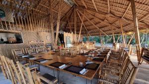 a large dining room with a large wooden table and chairs at SunBoo Beach Bungalows in Koh Rong Sanloem