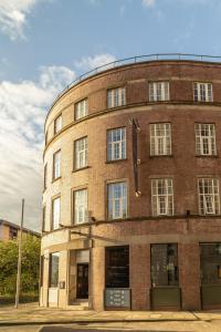 a round brick building with windows on a street at Kabannas Newcastle in Newcastle upon Tyne