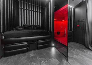 a bedroom with a black bed and red lighting at Eclipse Red Room in Bielsko-Biała