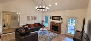 a living room with a couch and a fireplace at Meadow Farm in Holly Springs, NC in Holly Springs