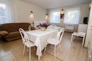 a living room with a white table and chairs at Elena in Palanga