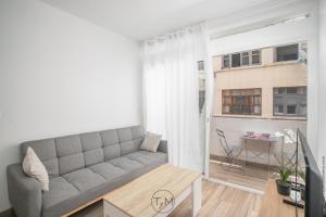 a living room with a couch and a window at Carré d'as in Fort-de-France